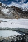 Two porters walking across the Cho La Glacier