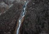Birch forest and frozen waterfall on the slopes of the Nagpi Danda