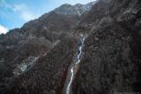 Birch forest and frozen waterfall on the slopes of the Nagpi Danda