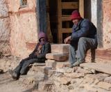 Two of our crew resting at the entrance of the gompa